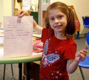 Violet (age 5), a student at Roosevelt Elementary, holds her recipe for s'mores