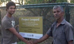 Sanjiv Fernando '15 (left) shakes hands with W.P. Piyadasa, a cattle herder who received one of the mesh enclosures. 